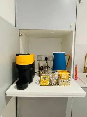 a shelf with a coffee maker and other items on it at Designer Studio in Edinburgh with Free Parking in Edinburgh