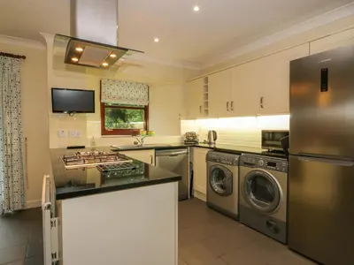 a kitchen with a stainless steel refrigerator and a dishwasher at The Barn at Daldorch in Mauchline