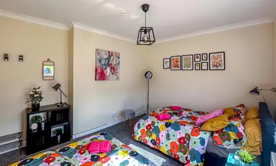 a bedroom with two beds in a room at Colourful life-house near Glasgow in Clydebank