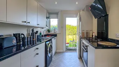 a kitchen with a washer and dryer at Colourful life-house near Glasgow in Clydebank