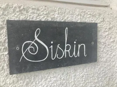 a sign on a wall with the word dublin at Siskin Cottage in Lochgilphead