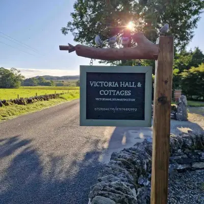 a sign on a pole next to a road at Siskin Cottage in Lochgilphead