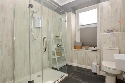 a bathroom with a shower and a toilet and a sink at Crossaig Farm House in Crossaig