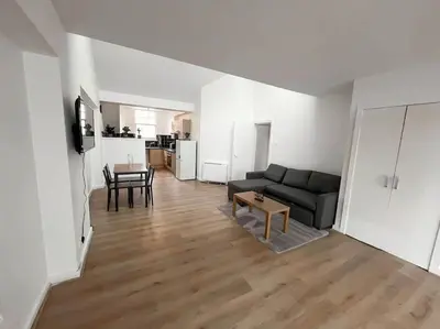 a living room with a couch and a table at Edinburgh elms for 4 - New Town - City Center EB8 in Edinburgh