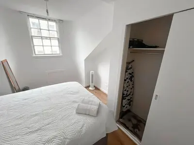 a white bedroom with a bed and a window at Edinburgh elms for 4 - New Town - City Center EB8 in Edinburgh