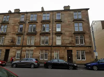 three cars parked in front of a brick building at 2B apartment near Glasgow SEC, OVO Hydro & city centre in Glasgow