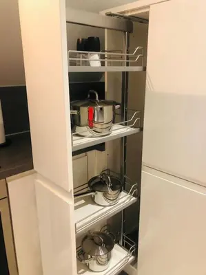 a kitchen pantry with pots and pans and a refrigerator at The Orchard Apartment, Clyde Valley in Dalserf
