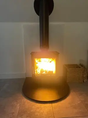 a fireplace in the corner of a room at The Orchard Apartment, Clyde Valley in Dalserf