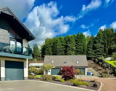 a house with a balcony on the side of it at The Orchard Apartment, Clyde Valley in Dalserf