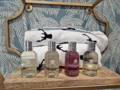a group of four bottles of soap on a table at Lyne Cottage, The Retreat in West Linton