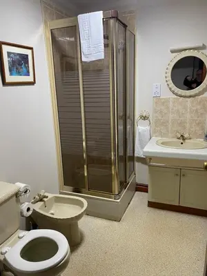 a bathroom with a toilet and a shower and a sink at townhouse apartments in Ayr
