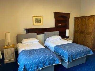 a hotel room with two beds with blue and white sheets at townhouse apartments in Ayr