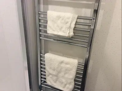 a towel rack in a refrigerator with white towels at 103 NELSON STREET Aubery in Largs