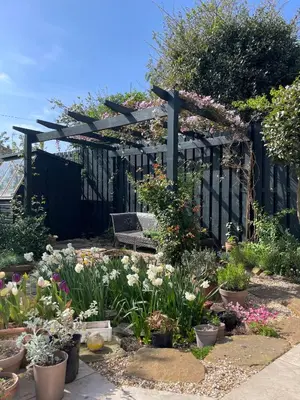 a garden with flowers and a black fence at Beautiful double room B&B great location homeshare Edinburgh in Edinburgh