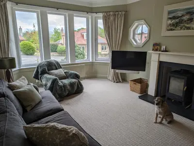 a living room with a couch and a fireplace at Beautiful double room B&B great location homeshare Edinburgh in Edinburgh