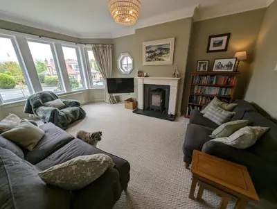 a living room with a couch and a fireplace at Beautiful double room B&B great location homeshare Edinburgh in Edinburgh