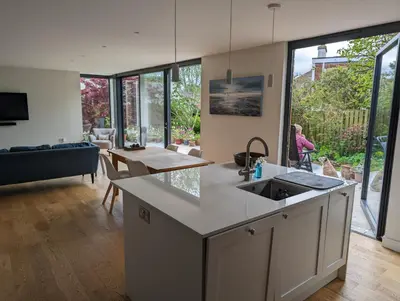 a kitchen with a sink and a living room at Beautiful double room B&B great location homeshare Edinburgh in Edinburgh
