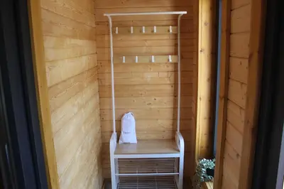 a sauna with a table and a chair in it at Ghillie's Croft Cabin, Rothesay in Rothesay