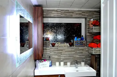 a bathroom with a sink and a mirror at Double room in riverside apartment in Glasgow