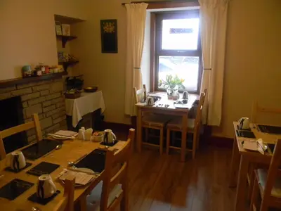 a dining room with a table and a window at Harbour Lights Guesthouse in Stranraer