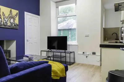 a living room with a couch and a tv at Braelochan Stay in Balloch