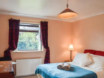 a bedroom with a bed with two towels on it at Wallace View in Stirling