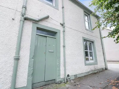 a building with a green door and a window at West Morton House in Thornhill
