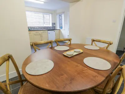 a dining room table with four chairs around it at West Morton House in Thornhill