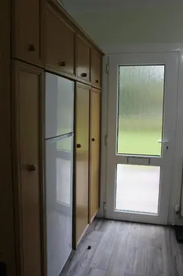 an empty kitchen with a refrigerator and a window at Lednabra Cottage in Drymen