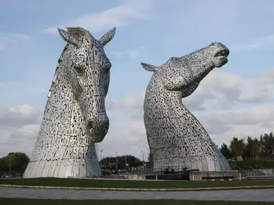 two statues of two horses standing next to each other at Oak in Denny