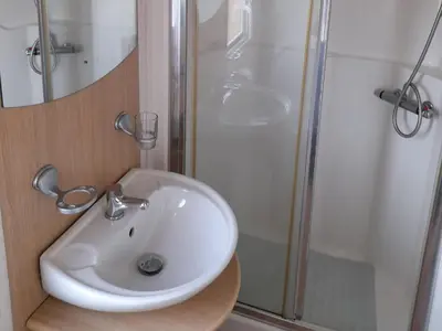 a bathroom with a sink and a shower at Oak in Denny