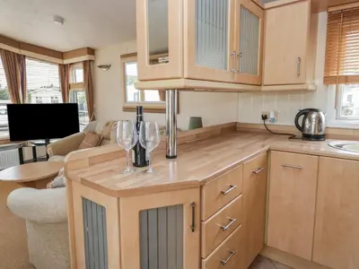a kitchen with two wine glasses on a counter at Birch in Denny