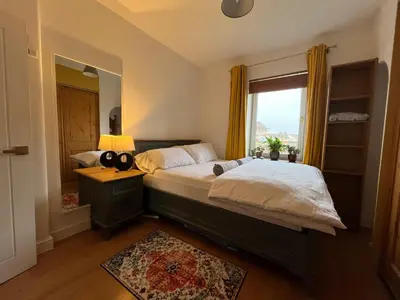 a bedroom with a large bed and a window at Frans Place in Edinburgh