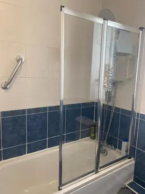 a shower with a glass door in a bathroom at Frans Place in Edinburgh