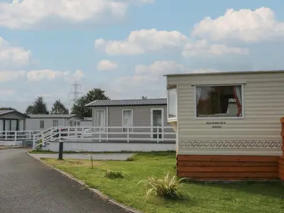 a mobile home is parked in a parking lot at Holly in Denny
