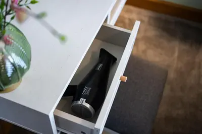 a bottle of wine in a white drawer at 24 Kingsford Court in Newton Mearns