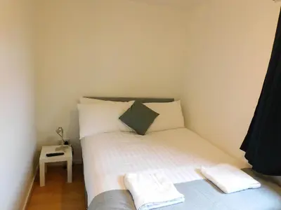 a small bedroom with a bed and a table at No 52 - Newly refurbished 3 bedroom home in East Kilbride in East Kilbride