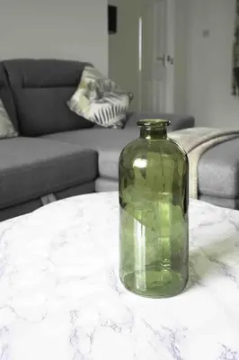 a green vase sitting on a table in a living room at Redding House in Falkirk