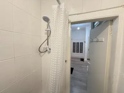 a shower with a shower head in a bathroom at 2 Bed Flat - Street Parking in Glasgow