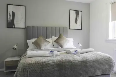 a bedroom with a large bed with two towels on it at Granby House in Livingston