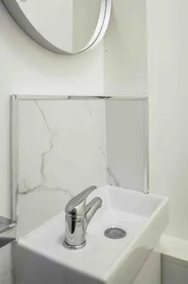 a white sink in a bathroom with a mirror at Granby House in Livingston