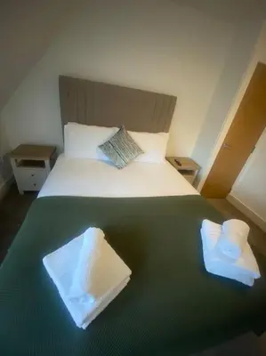 a bedroom with a bed with two towels on it at 5 Smithhills Paisley Central GLW & Glasgow access in Paisley