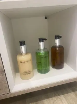 three bottles of soap are sitting on a shelf at 5 Smithhills Paisley Central GLW & Glasgow access in Paisley