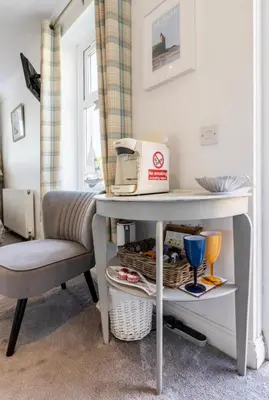 a table and a chair in a room at Beach room in Ayr