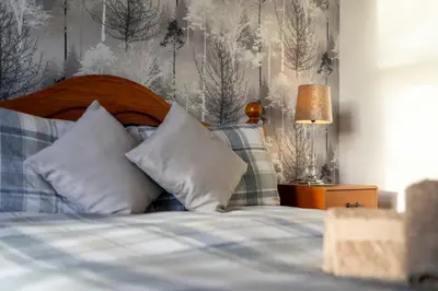 a bedroom with a bed with a wooden head board at Charming 1-Bedroom Home in Alexandria in Alexandria