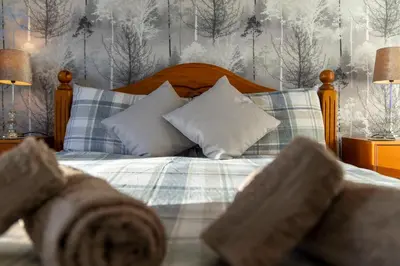 a bedroom with a bed with blue and white pillows at Charming 1-Bedroom Home in Alexandria in Alexandria