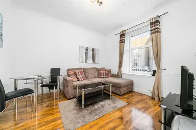 a living room with a couch and a table at Charming 1-Bedroom Home in Alexandria in Alexandria