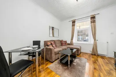 a living room with a couch and a table at Charming 1-Bedroom Home in Alexandria in Alexandria