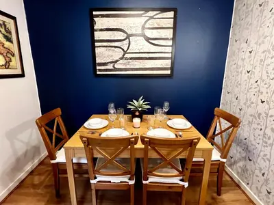 a dining room with a wooden table with chairs at Ground Floor Flat with Free Parking & WiFi in Glasgow