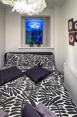 a bedroom with a black and white bed and a window at Brand New Scotland home 3rooms near Glasgow in Clydebank